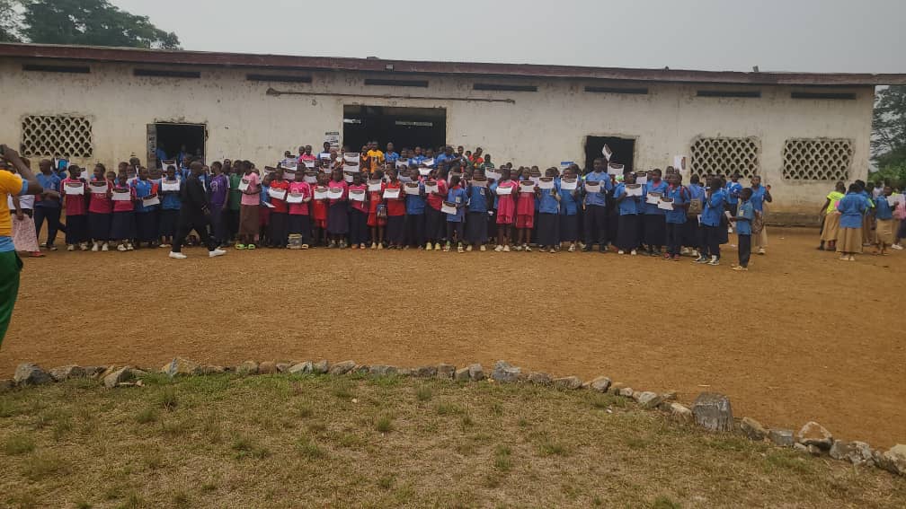 Students at the playground receiving the certificates